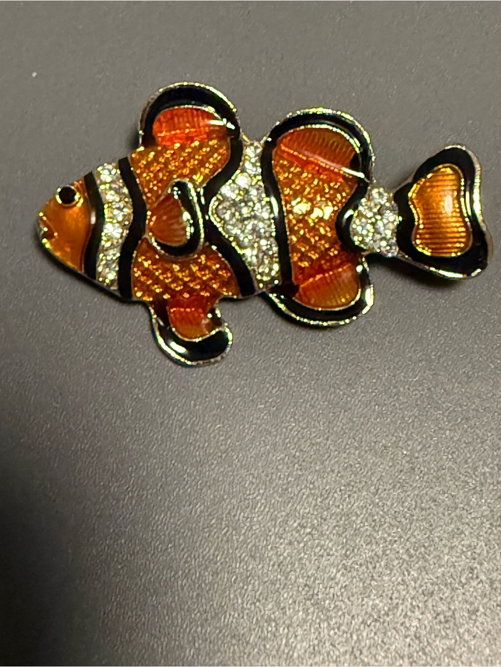 clownfish brooch featuring vibrant orange and black enamel